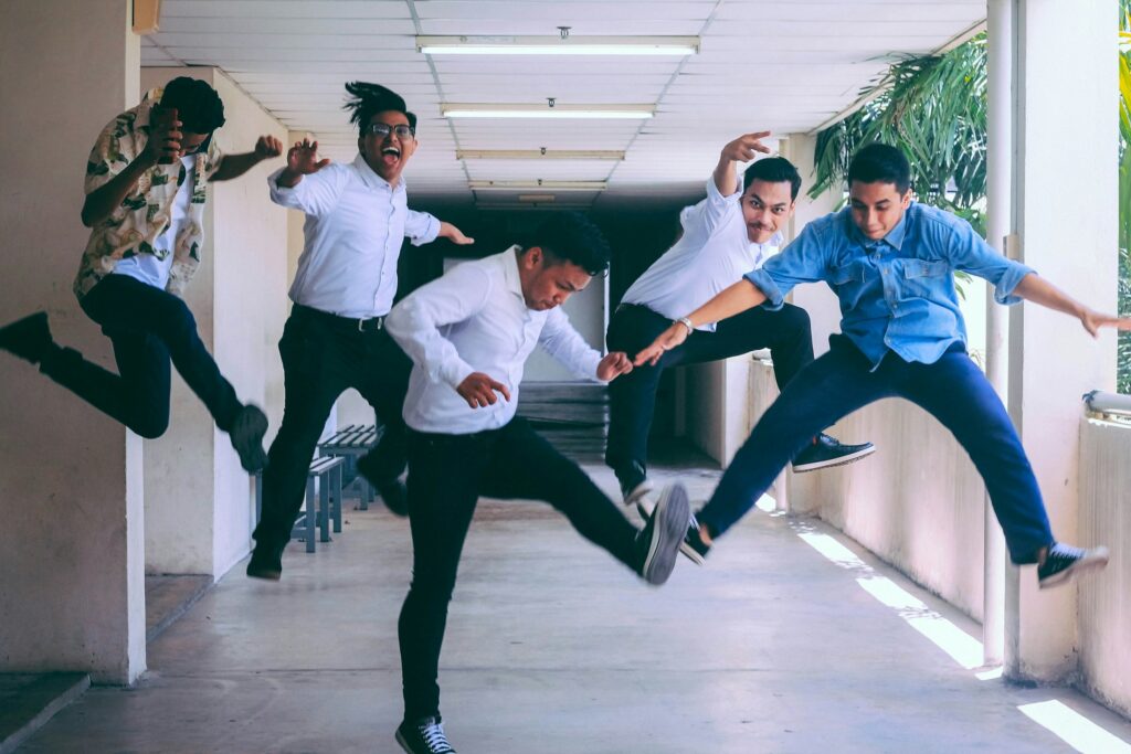 Group of people doing jump shot Photo by Husna Miskandar on Unsplash