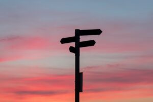 Silhouette of a road signage during golden hour Photo by Javier Allegue Barros on Unsplash