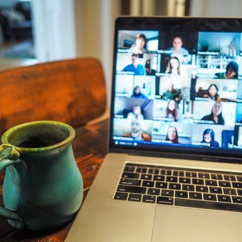 Macbook Pro displaying a group of people in a virtual meeting Photo by Chris Montgomery on Unsplash