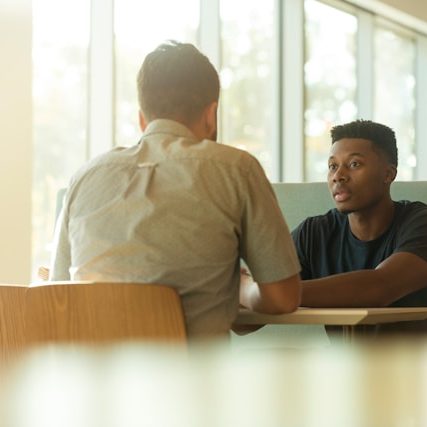 Two men talking Photo by LinkedIn Sales Solutions on Unsplash