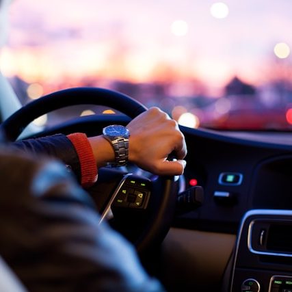 Man driving a car wearing a wristwatch Photo by why kei on Unsplash